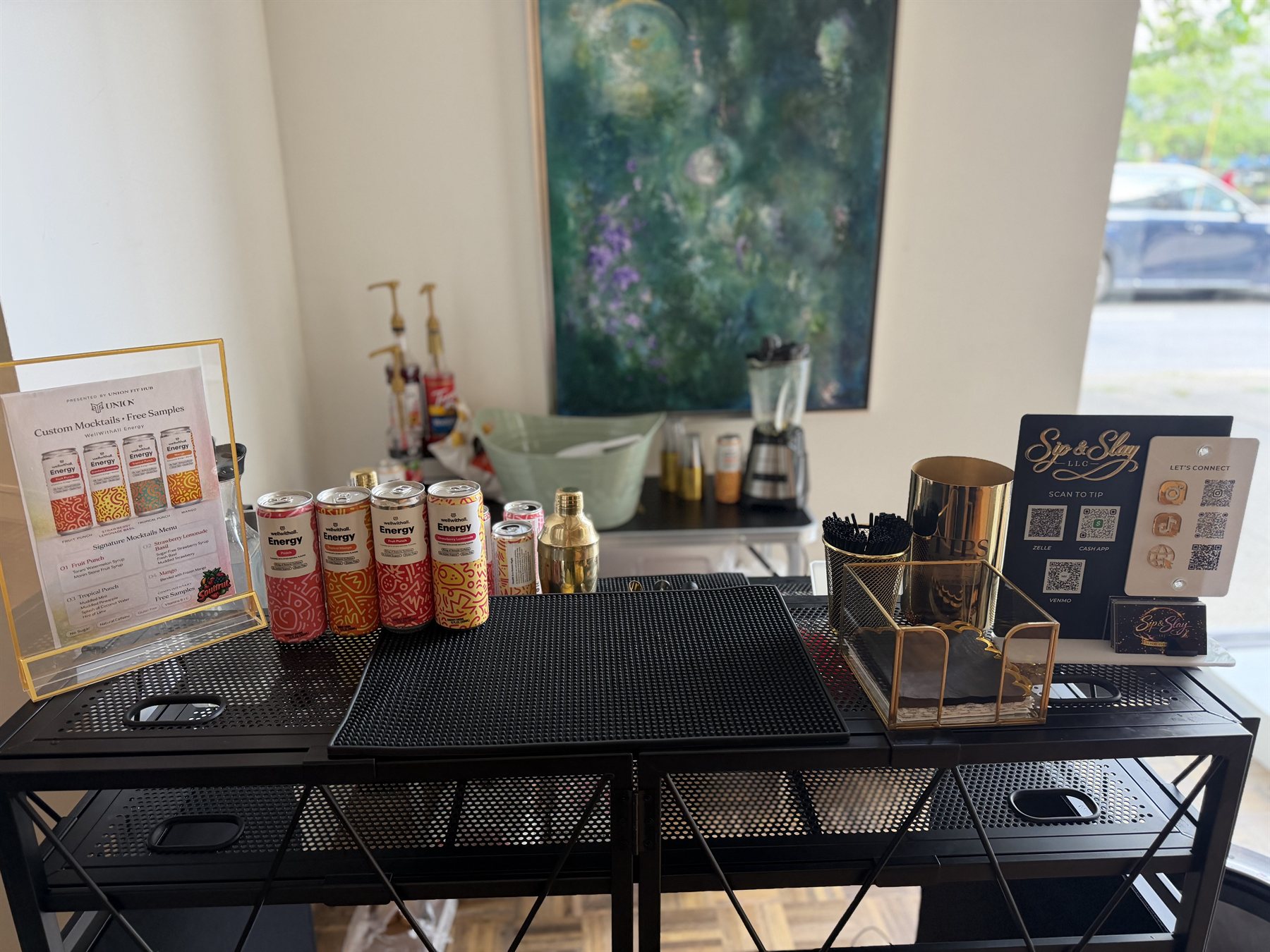 Sip & Slay bar cart styled with a custom mocktail menu, gold accents and tip station